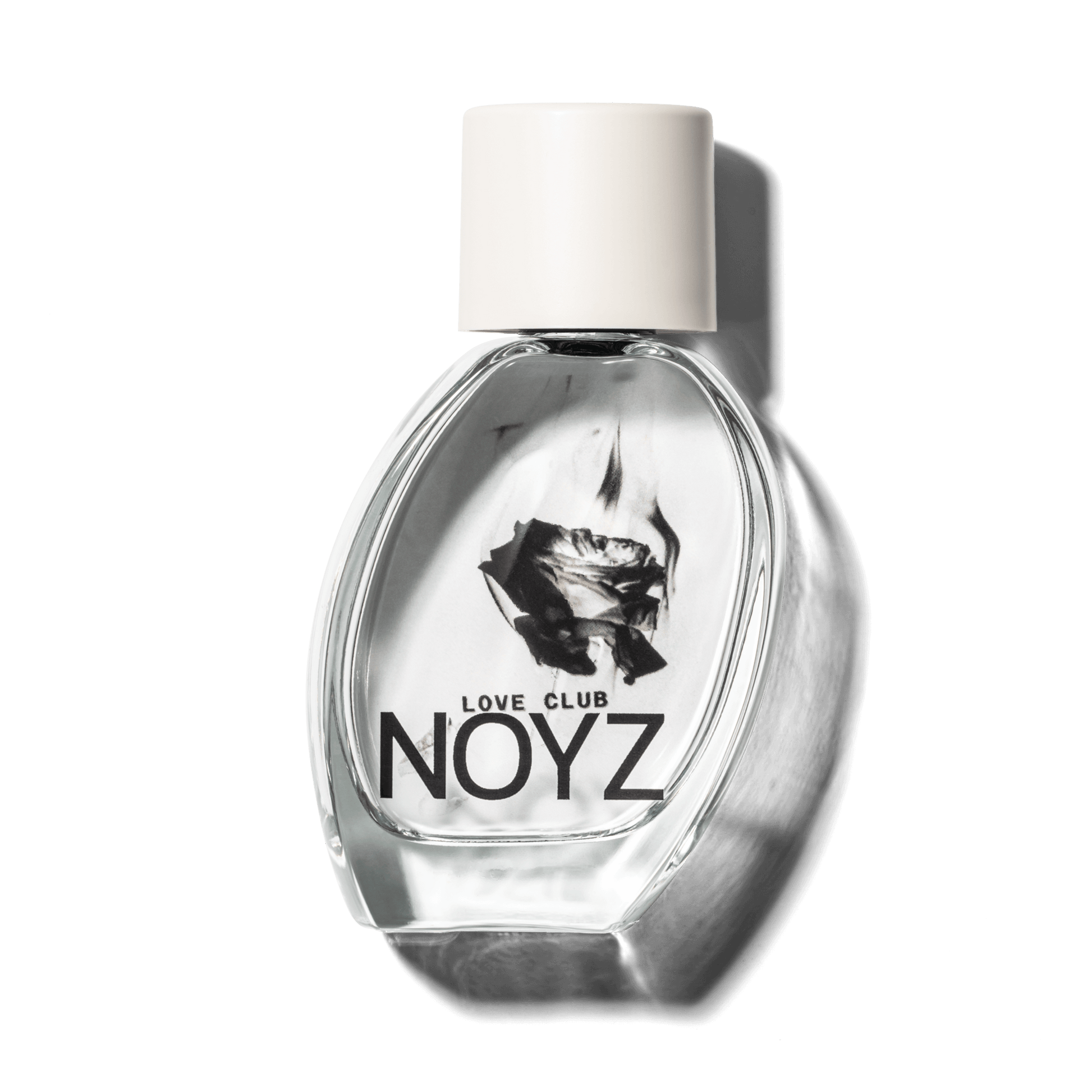 A slightly leaning, glass bottle of NOYZ Love Club, a sustainably crafted, fresh perfume