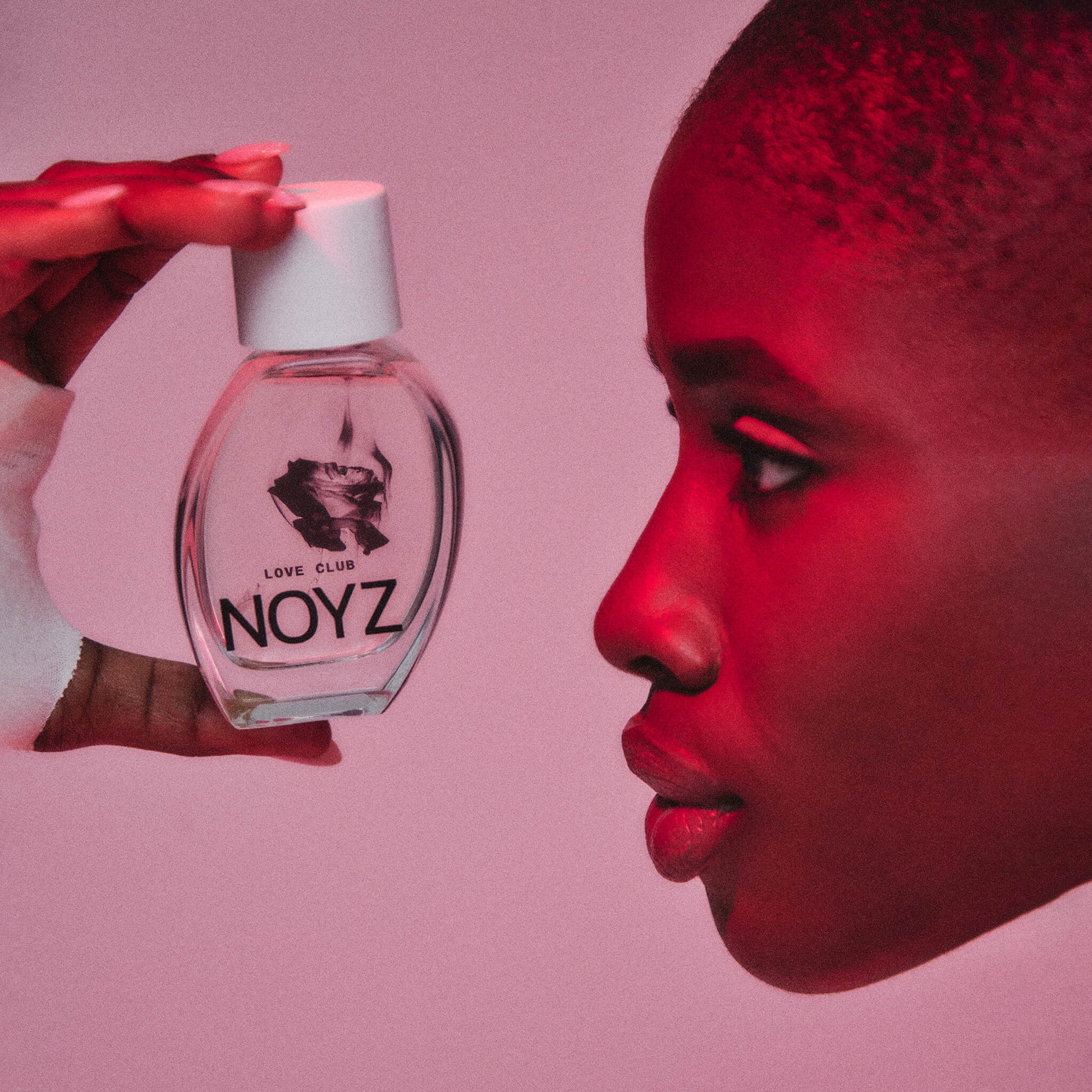 Model holding Love Club 50ml. Pink background