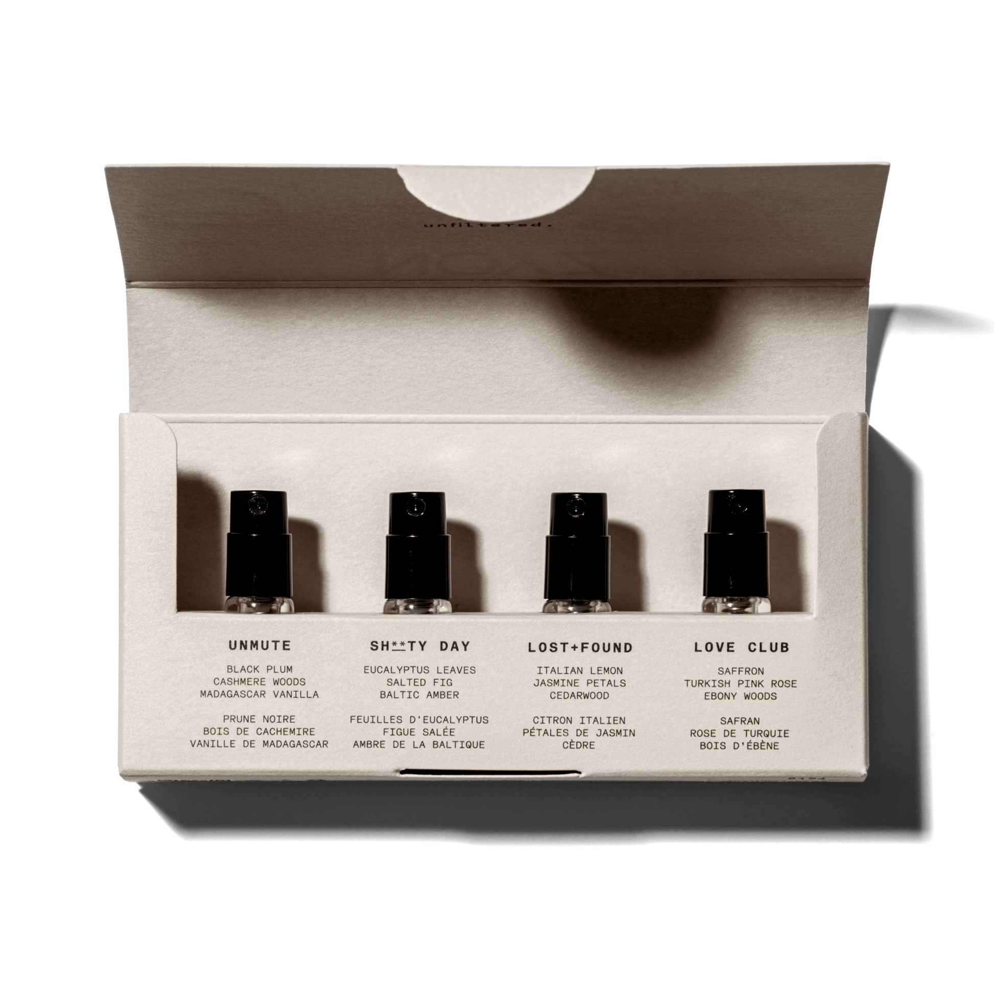 A minimalist box of all 4 NOYZ perfumes with the top open shows all 4 sample fragrance bottles inside. Best unisex scent.