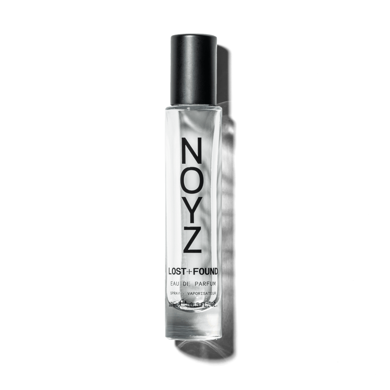 An asymmetrical glass bottle of NOYZ Lost + Found perfume and a box of its sustainable packaging