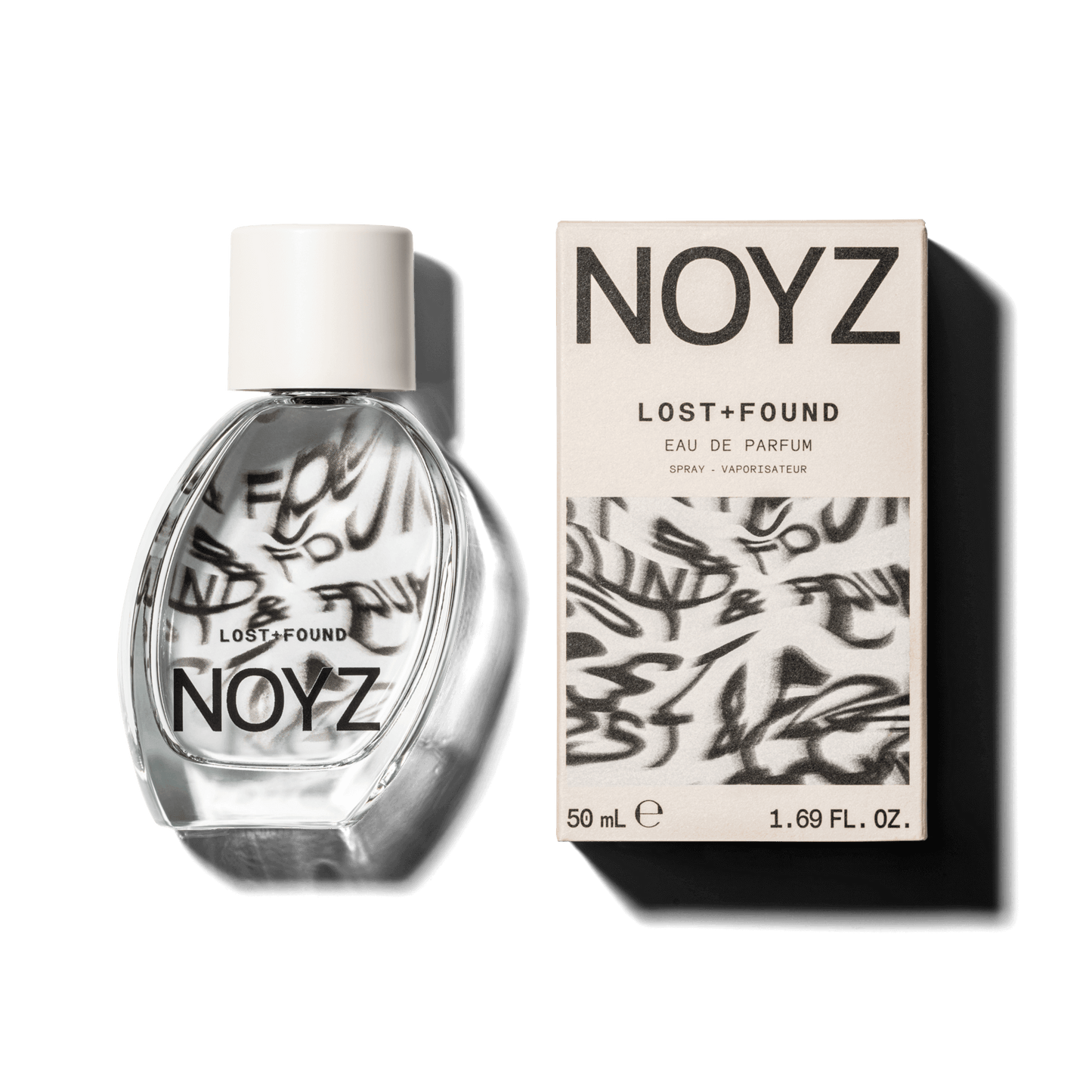 An asymmetrical glass bottle of Noyz Lost + Found perfume and a box of its sustainable packaging