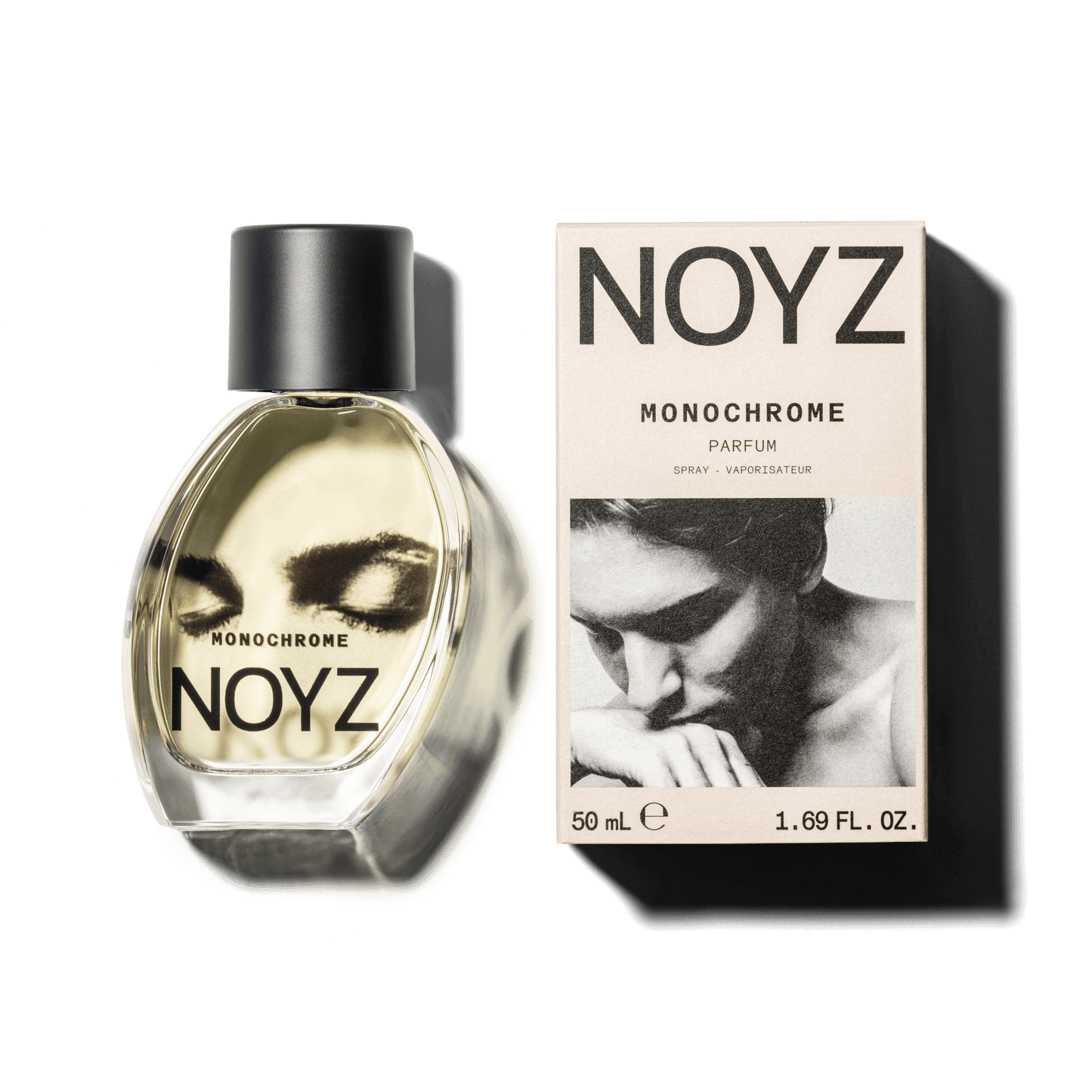 An asymmetrical glass bottle of Noyz Monochrome perfume and a box of its sustainable packaging