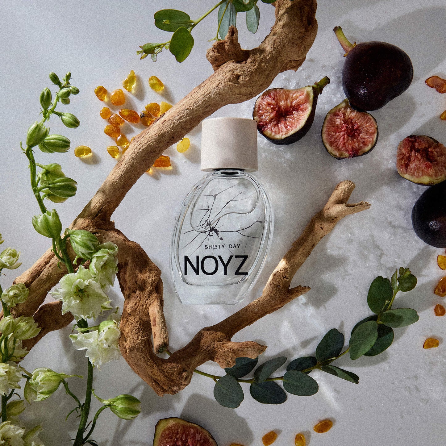 NOYZ perfume Sh**ty Day surrounded by sage leaves, figs, amber and ocean sale. Sexiest summer fragrance.