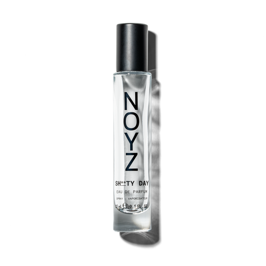 A small 15 ml glass bottle of Noyz Sh**ty Day top unisex fragrance