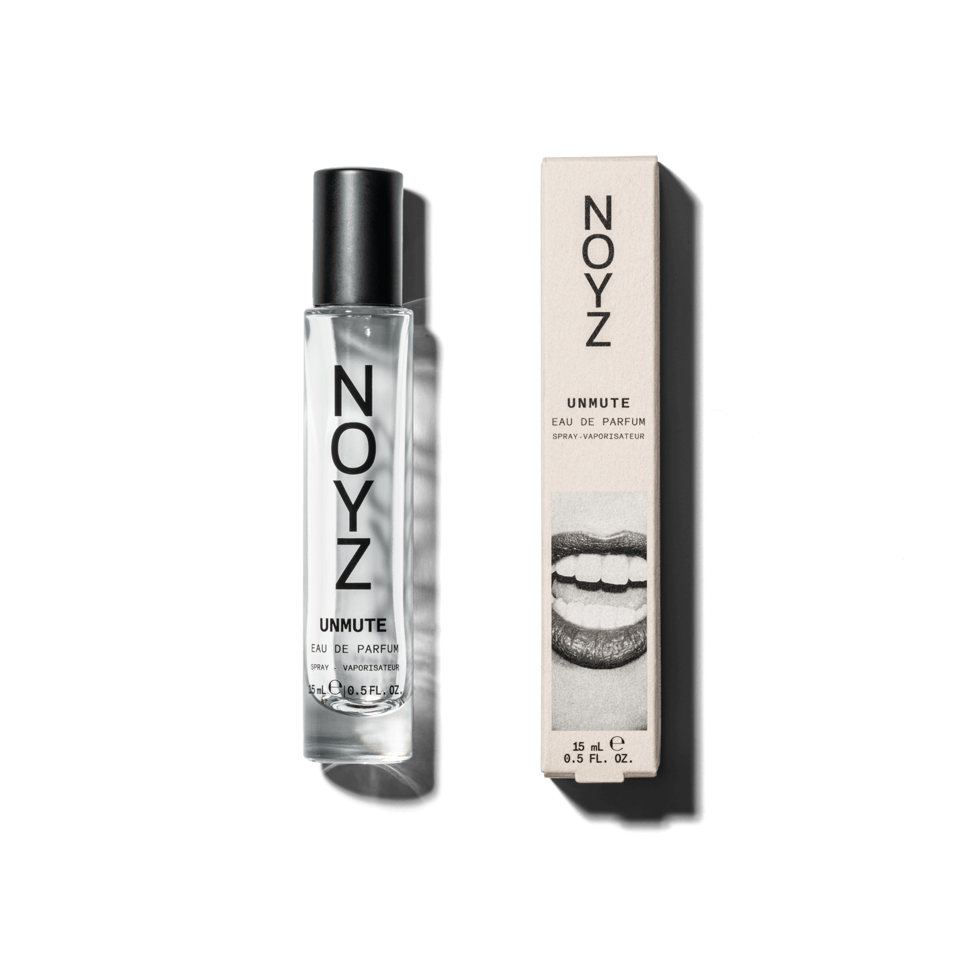A small 15 ml glass bottle of Noyz Unmute unisex perfume sits alongside its packaging box