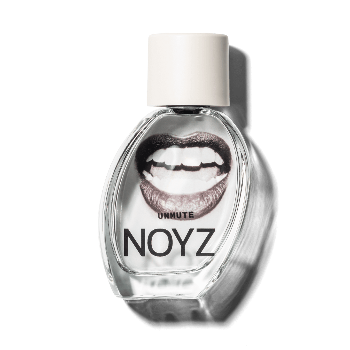A bottle of NOYZ perfume Unmute features an open mouth. Discover this perfume with vanilla notes
