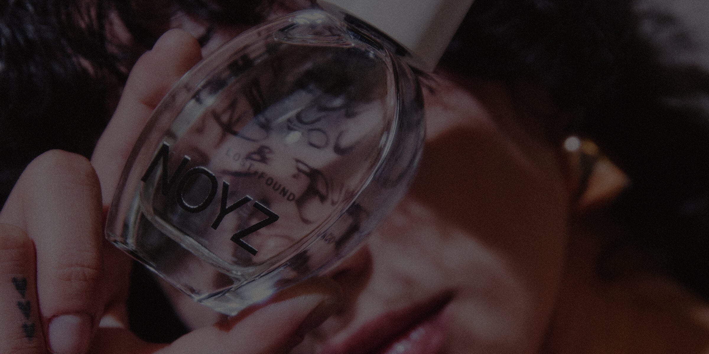 Abstract zoomed in shot of NOYZ Lost + Found womens and unisex perfum in a moody environment