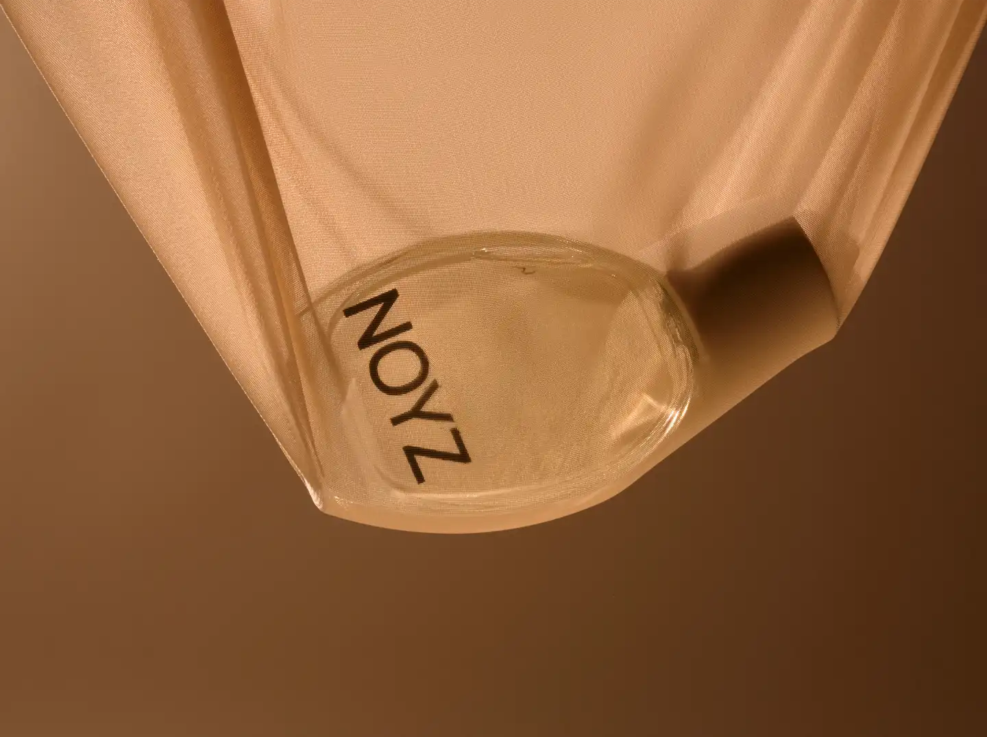 NOYZ product bottle with fabric overlay